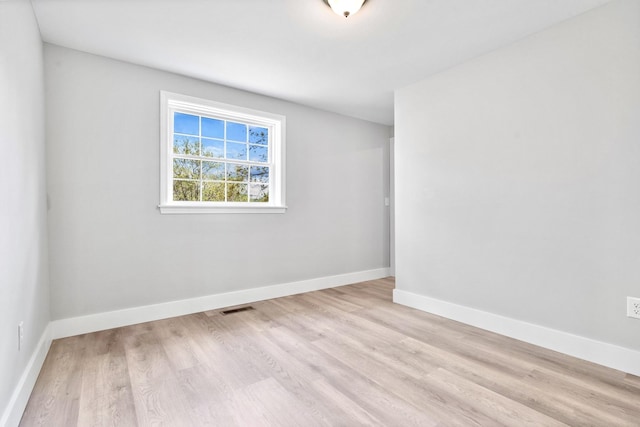 empty room with wood finished floors and baseboards
