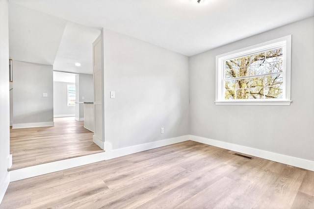 unfurnished room with wood finished floors and baseboards