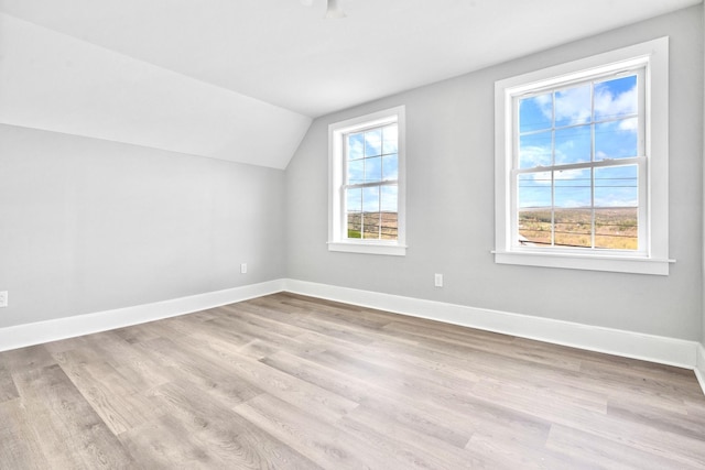 bonus room with lofted ceiling, wood finished floors, and baseboards