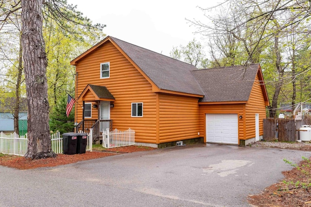 40 Butternut Ln, Conway, NH 03813 - view of front of house featuring a shingled roof, an attached garage, asphalt driveway, and log veneer siding