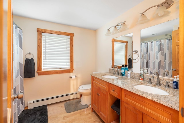 40 Butternut Ln, Conway, NH 03813 - full bath featuring baseboard heating, wood finished floors, toilet, double vanity, and a shower with curtain