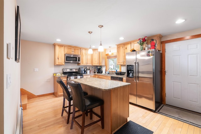 40 Butternut Ln, Conway, NH 03813 - kitchen featuring stainless steel appliances, a sink, light wood-style flooring, light brown cabinetry, and recessed lighting