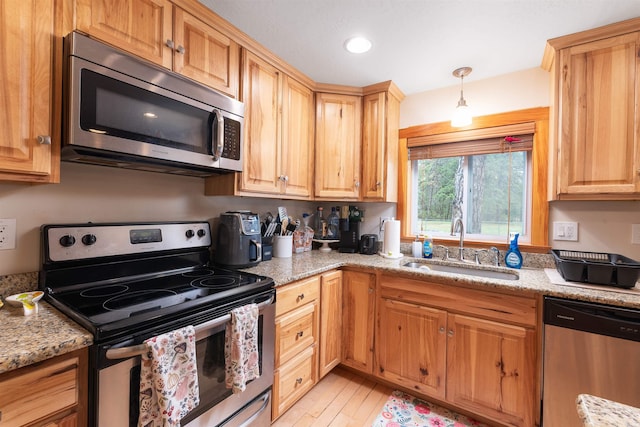 40 Butternut Ln, Conway, NH 03813 - kitchen featuring appliances with stainless steel finishes, a sink, light wood-style floors, light stone counters, and recessed lighting