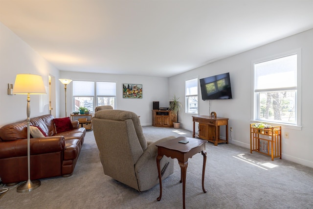 living room featuring plenty of natural light, carpet flooring, and baseboards