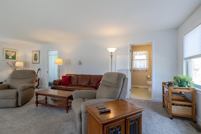 living area featuring light carpet