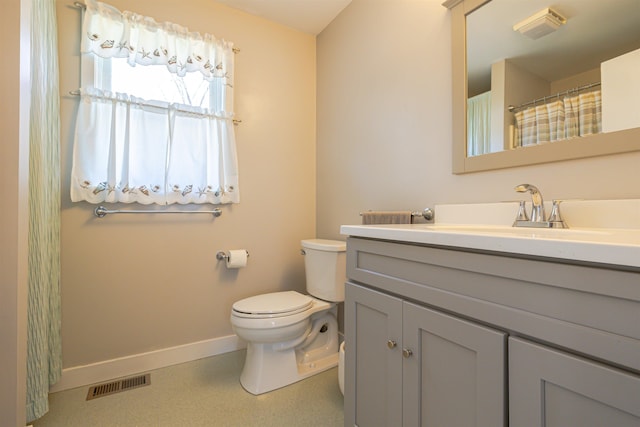 bathroom featuring baseboards, toilet, and vanity