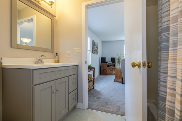 full bathroom featuring vanity, curtained shower, and baseboards