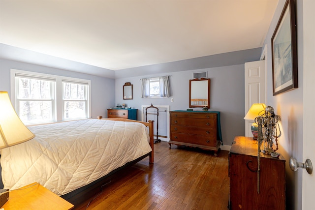 bedroom featuring wood finished floors and baseboards