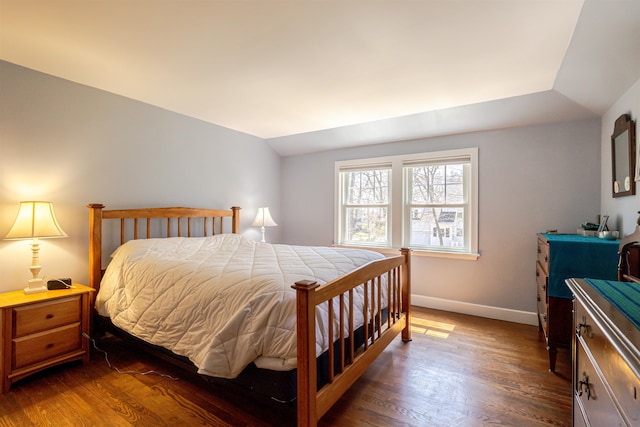 bedroom with dark wood-style floors and baseboards