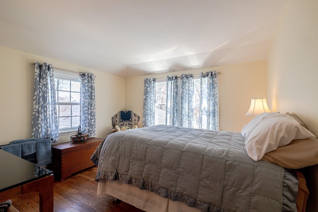bedroom featuring dark wood-type flooring and vaulted ceiling