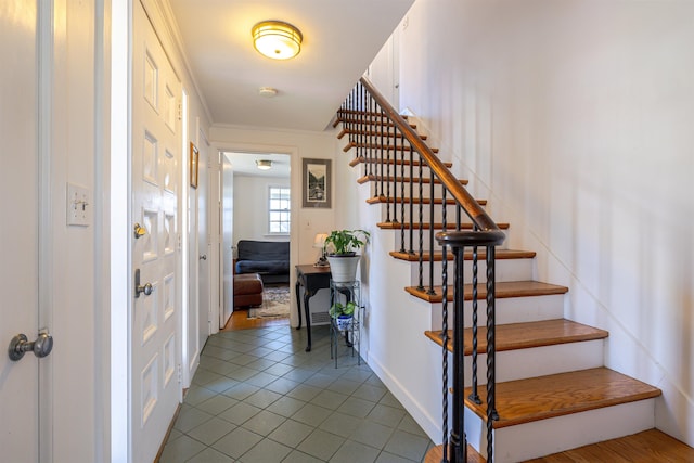 staircase featuring tile patterned flooring and baseboards