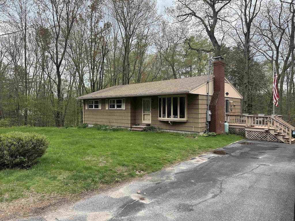 887 Harold Dow Hwy, Eliot, ME 03909 - ranch-style home with a chimney, a wooden deck, and a front yard