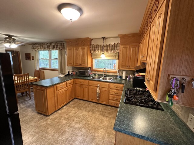 887 Harold Dow Hwy, Eliot, ME 03909 - kitchen featuring black appliances, a sink, a peninsula, ceiling fan, and tasteful backsplash