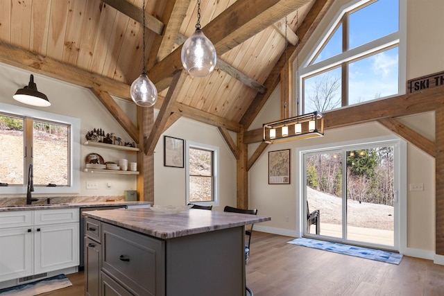 LOT22 Compass Point Rd, Thornton, NH 03285 - kitchen featuring plenty of natural light, light stone countertops, hanging light fixtures, light wood-style floors, and a wooden ceiling with exposed beams