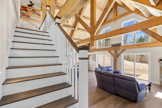 LOT22 Compass Point Rd, Thornton, NH 03285 - stairway with wood finished floors, high vaulted ceiling, beam ceiling, and a chandelier