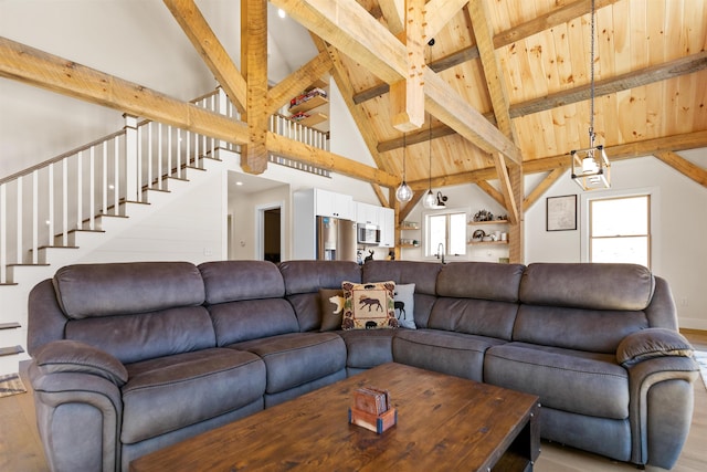 LOT22 Compass Point Rd, Thornton, NH 03285 - living room with light wood finished floors, stairs, beam ceiling, and high vaulted ceiling
