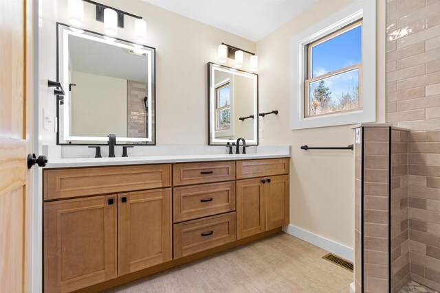 LOT22 Compass Point Rd, Thornton, NH 03285 - bathroom featuring double vanity, a tile shower, and wood finished floors