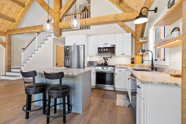 LOT22 Compass Point Rd, Thornton, NH 03285 - kitchen featuring appliances with stainless steel finishes, high vaulted ceiling, beamed ceiling, dark wood-style floors, and white cabinetry