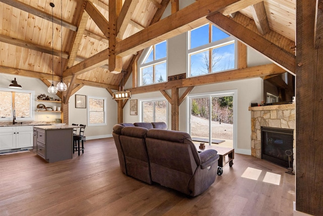 LOT22 Compass Point Rd, Thornton, NH 03285 - living area with high vaulted ceiling, a wooden ceiling with exposed beams, dark wood-type flooring, and a stone fireplace