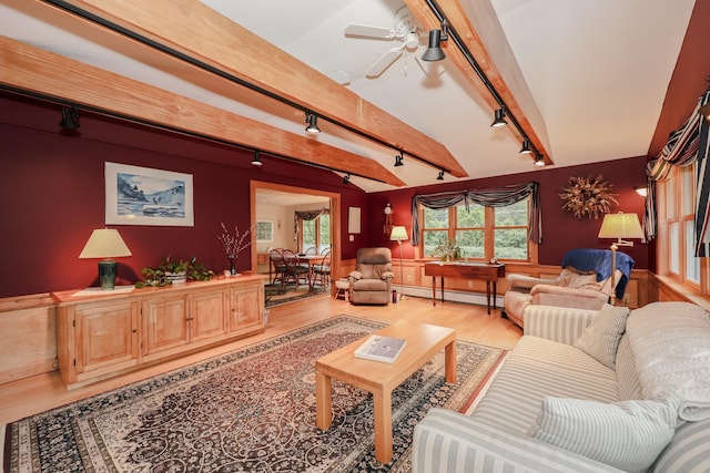 living area featuring rail lighting, light wood-type flooring, a baseboard heating unit, and beam ceiling