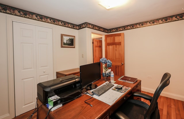 office with hardwood / wood-style floors and baseboards