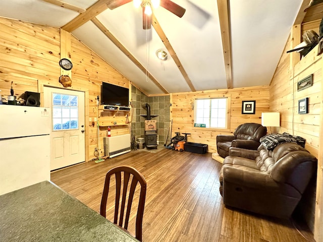 784 Nh Route 145, Clarksville, NH 03592 - living area featuring wooden walls, hardwood / wood-style floors, a ceiling fan, and a wood stove