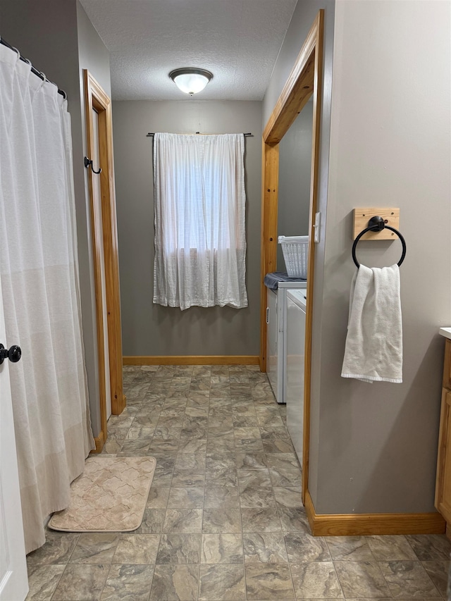 687 Chilafoux Hl, Irasburg, VT 05845 - bathroom featuring baseboards, a textured ceiling, stone finish floors, and vanity