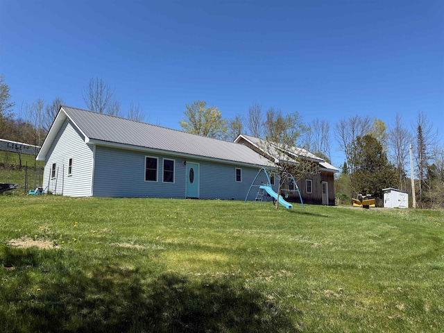 687 Chilafoux Hl, Irasburg, VT 05845 - back of property featuring a lawn, an outbuilding, a shed, and metal roof