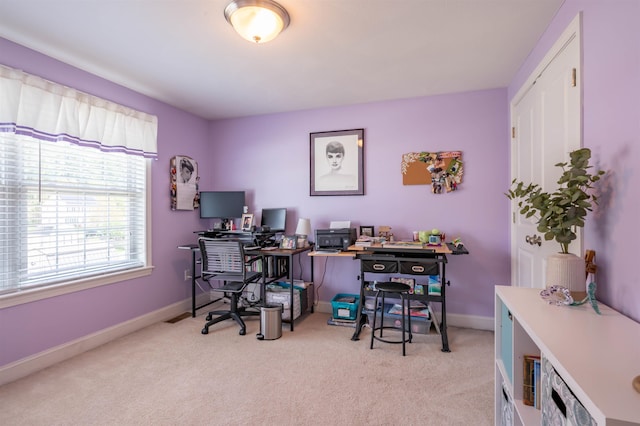 home office with light colored carpet and baseboards