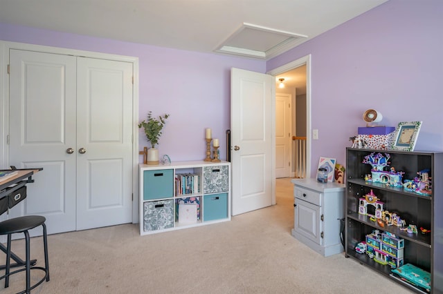 playroom featuring attic access and light colored carpet