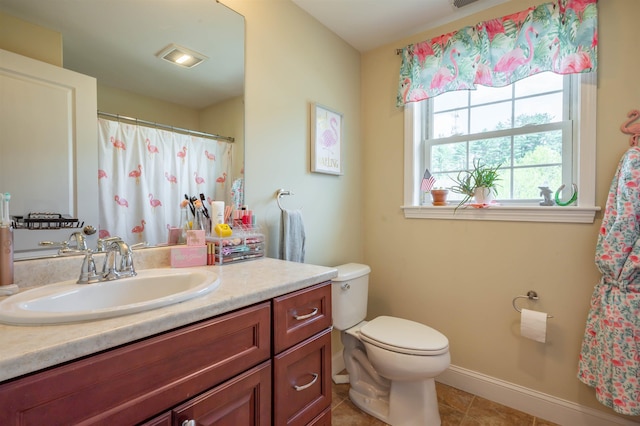 bathroom featuring toilet, tile patterned flooring, vanity, baseboards, and a shower with shower curtain