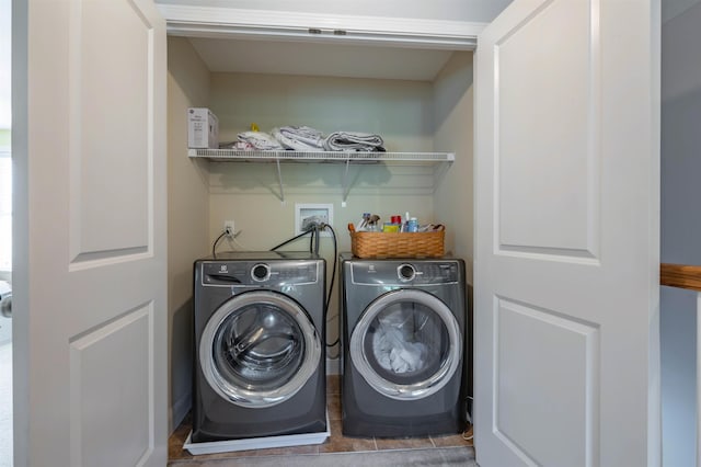 clothes washing area with separate washer and dryer