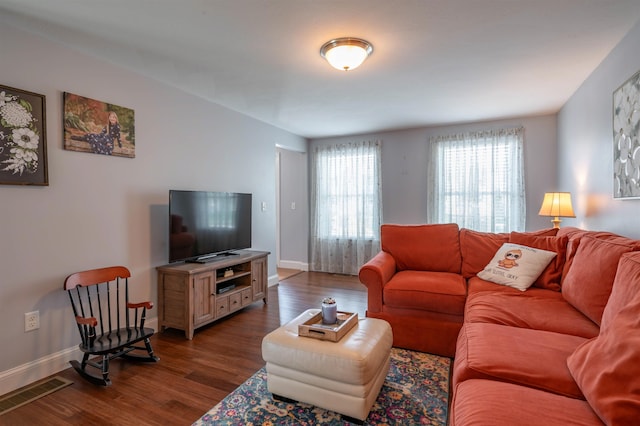 living room featuring dark wood-style floors and baseboards