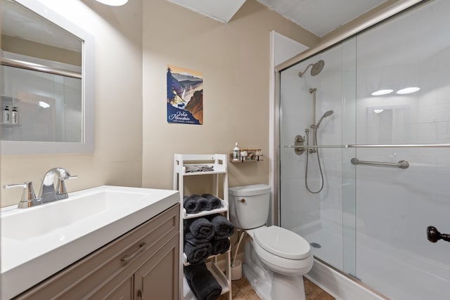 full bathroom with toilet, a shower stall, vanity, and tile patterned floors