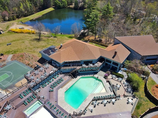 view from above of property featuring a pool and a large body of water