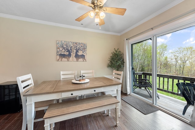 dining area featuring ornamental molding, wood finished floors, and ceiling fan