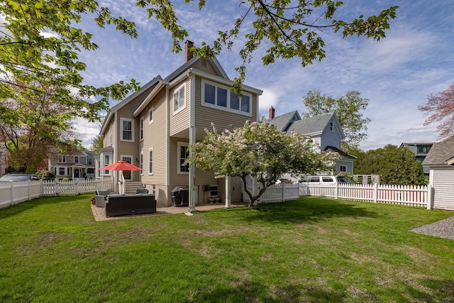 rear view of property with a chimney, a jacuzzi, and a patio area