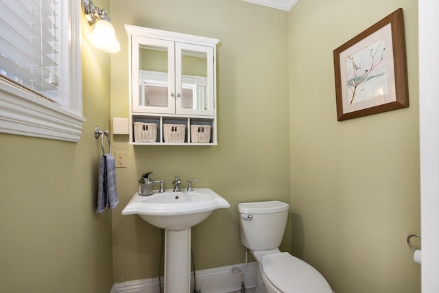 half bathroom featuring toilet and a sink