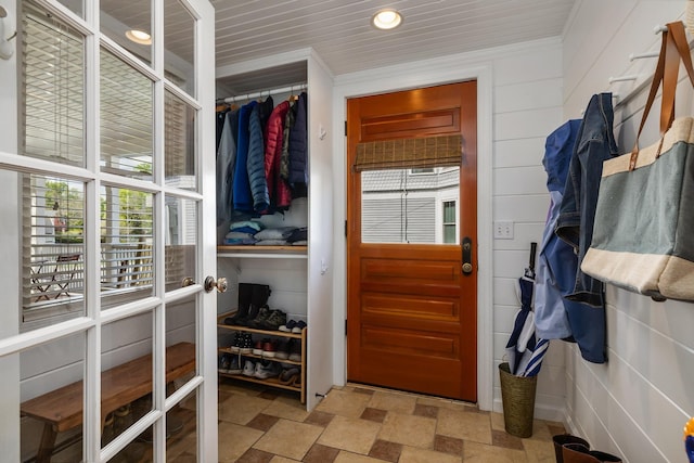 walk in closet featuring stone finish flooring