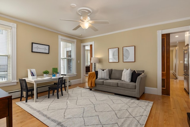 living room with ceiling fan, ornamental molding, light wood-style flooring, baseboards, and an office area