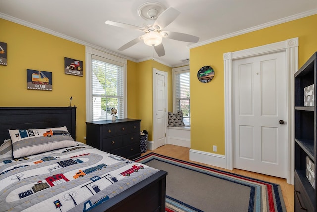 bedroom featuring light wood-type flooring, ornamental molding, baseboards, and multiple windows