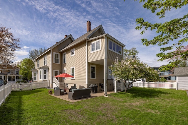 rear view of property featuring outdoor lounge area, a chimney, and a patio