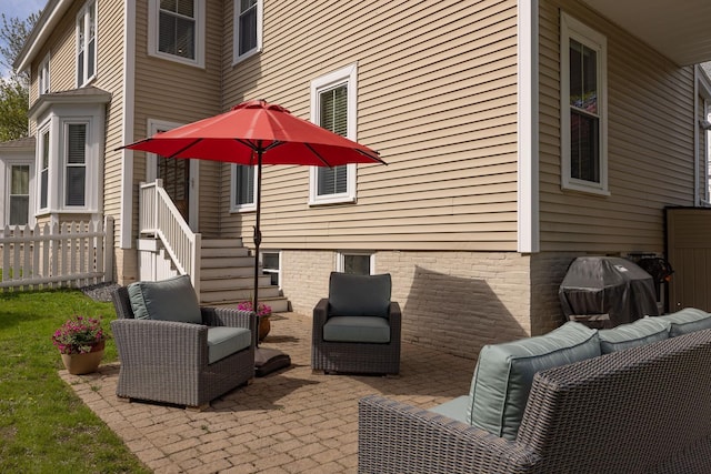 view of patio / terrace featuring an outdoor living space and fence