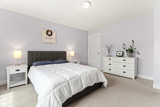 bedroom with light carpet and baseboards