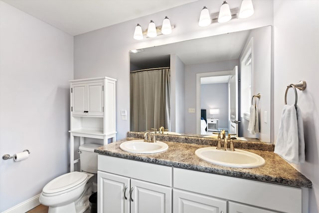 bathroom with toilet, double vanity, and a shower with curtain