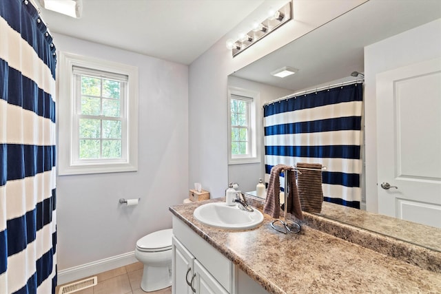 full bathroom featuring baseboards, plenty of natural light, tile patterned flooring, and toilet