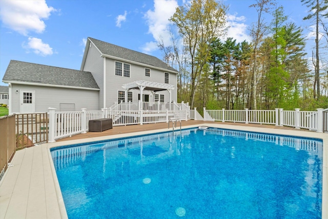view of swimming pool with a pergola, a deck, and fence