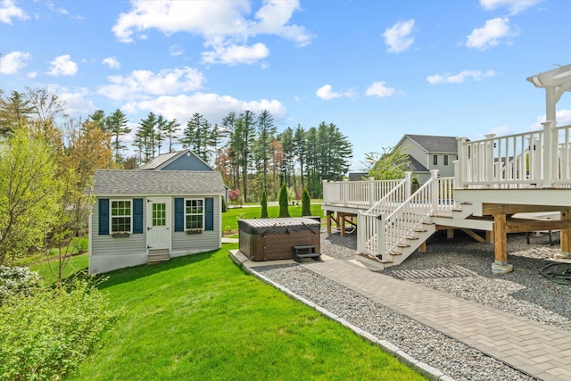 view of green lawn featuring a hot tub, a wooden deck, stairway, an outdoor structure, and entry steps