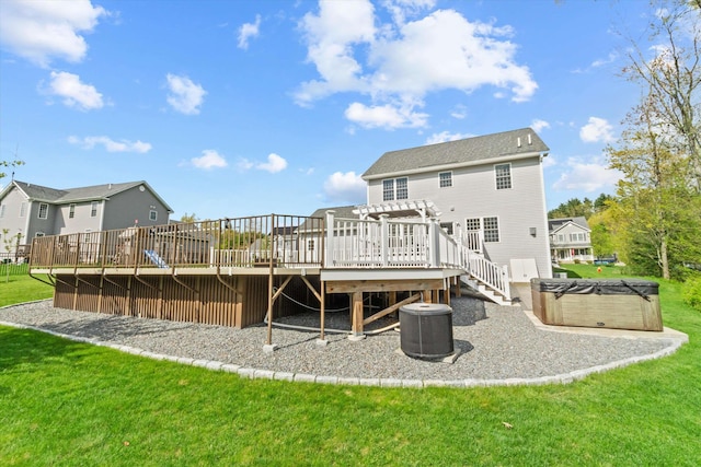 back of house with a hot tub, a wooden deck, cooling unit, a lawn, and a pergola