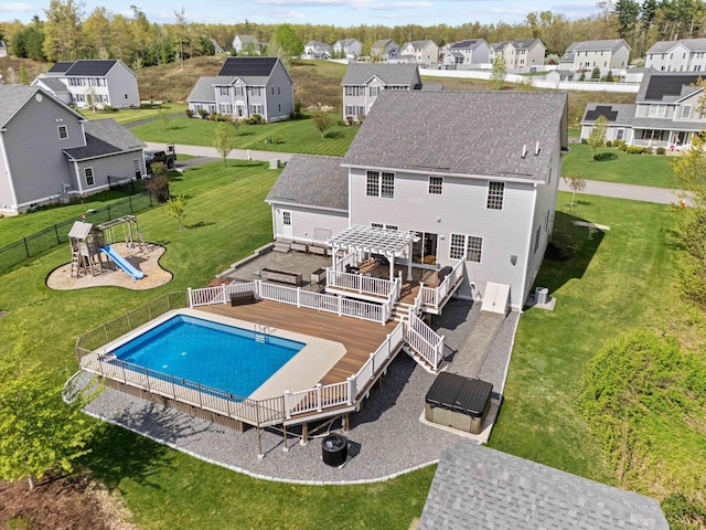 view of pool featuring a deck, a residential view, a pergola, and a playground